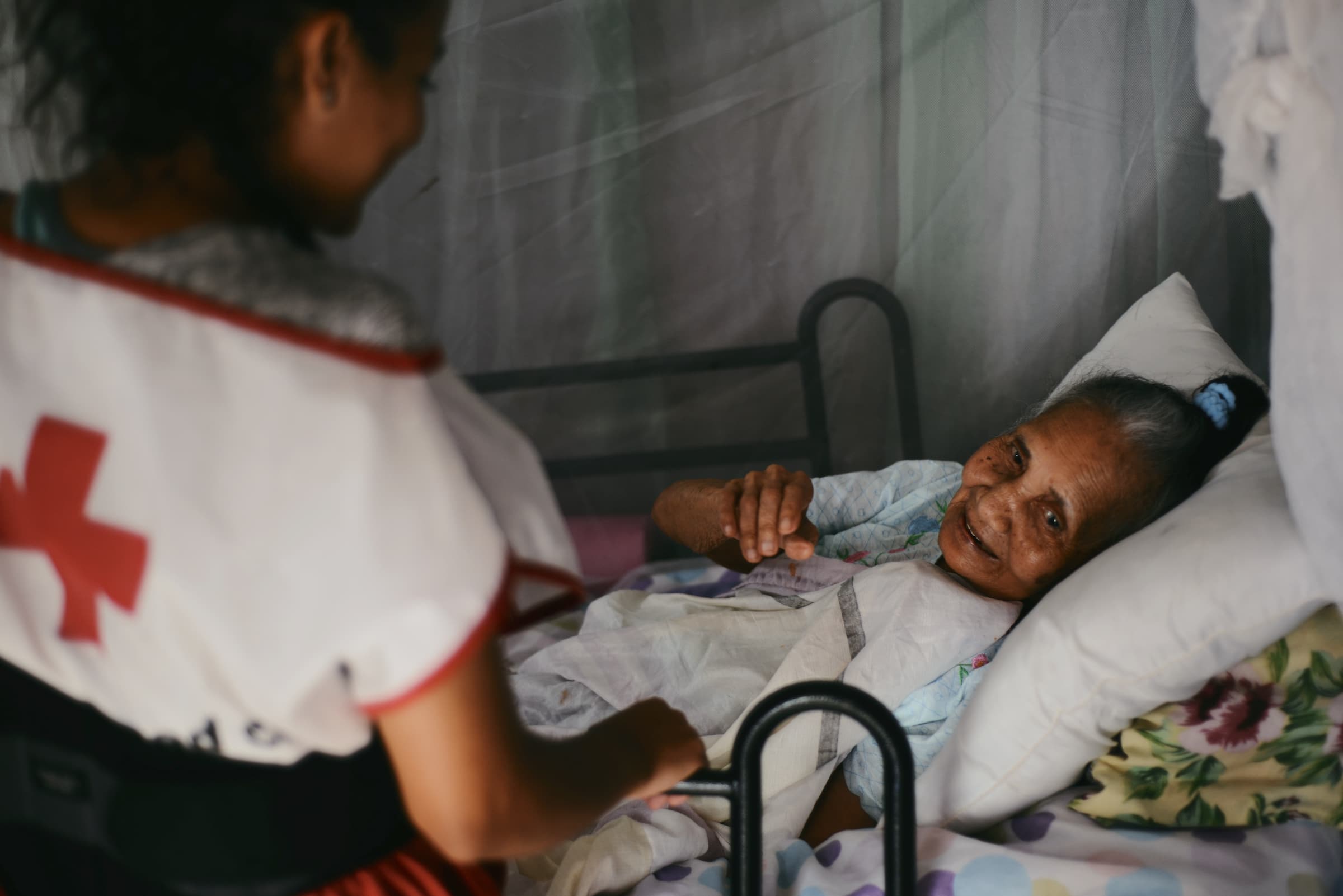 A Red Cross advocate visits a bedridden Hurricane Maria survivor in Maunabo, Puerto Rico