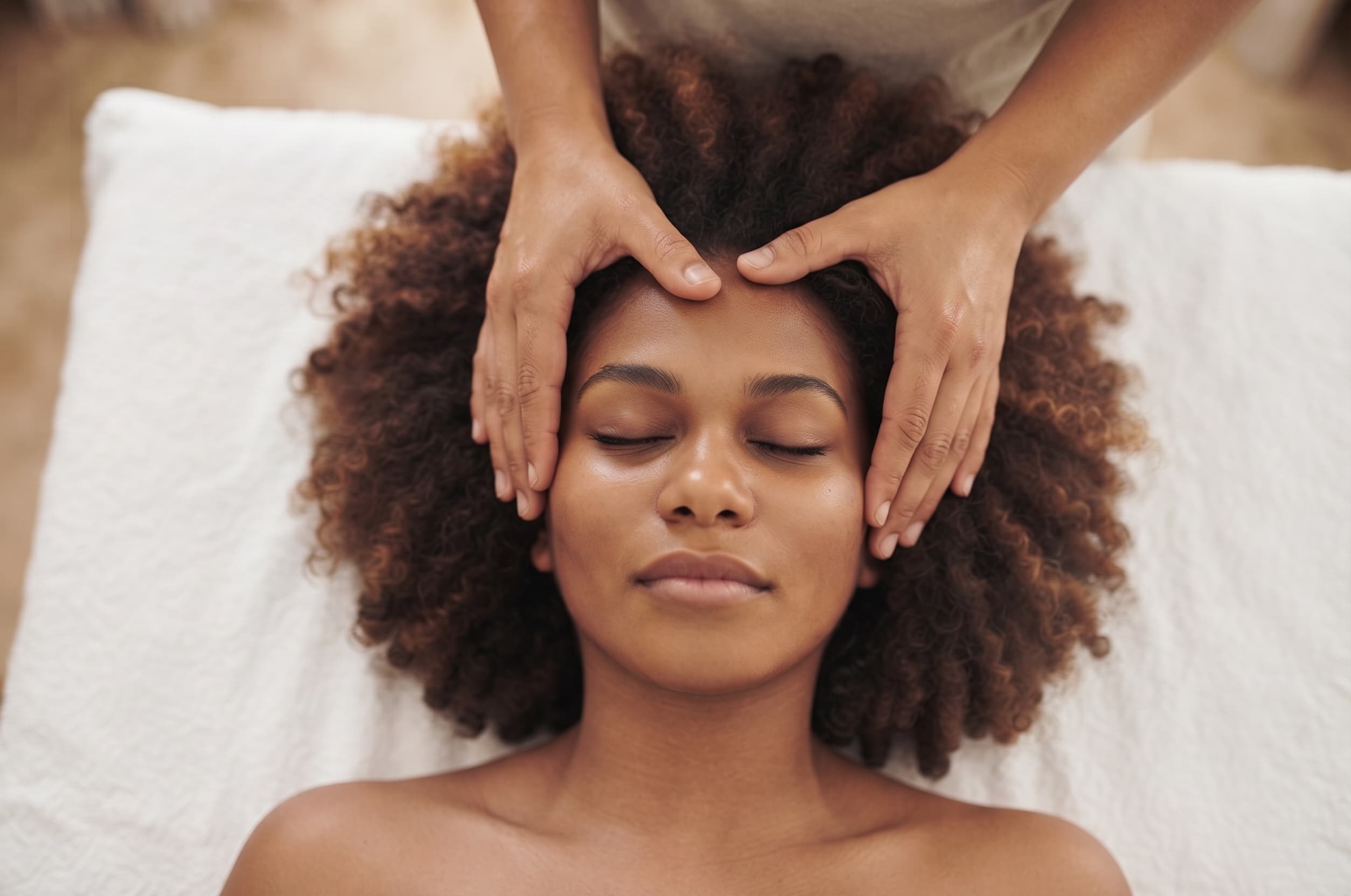 Practitioner gently placing healing hands above a client during a Green Fire Reiki session
